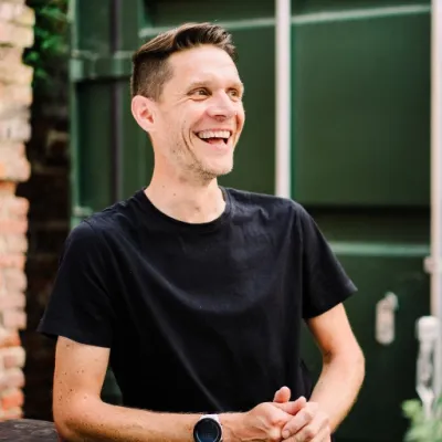 Photograph of Adam Chamberlin in the outside working space at The Mackman Group